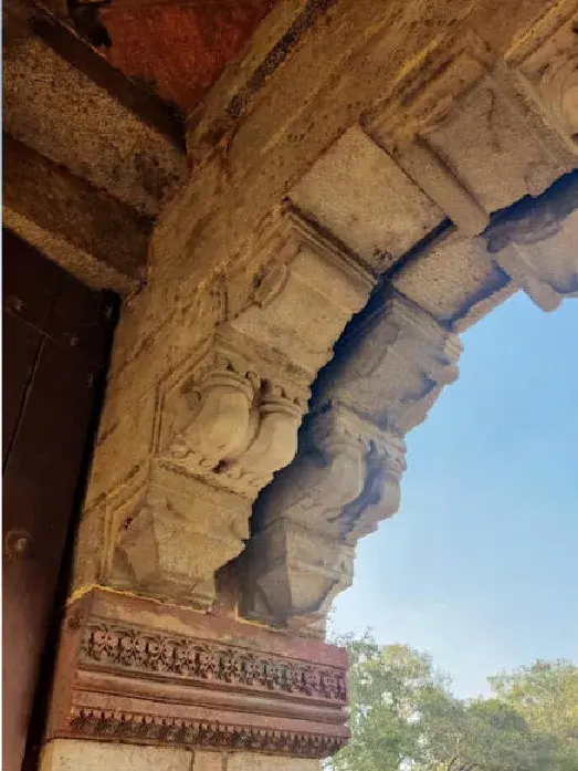 A carved stone bracket meeting an arch