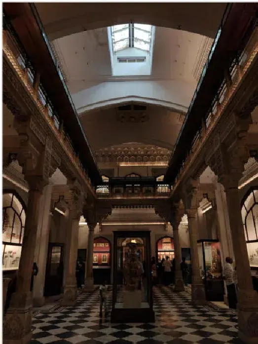 A colonnaded museum hall under a skylight